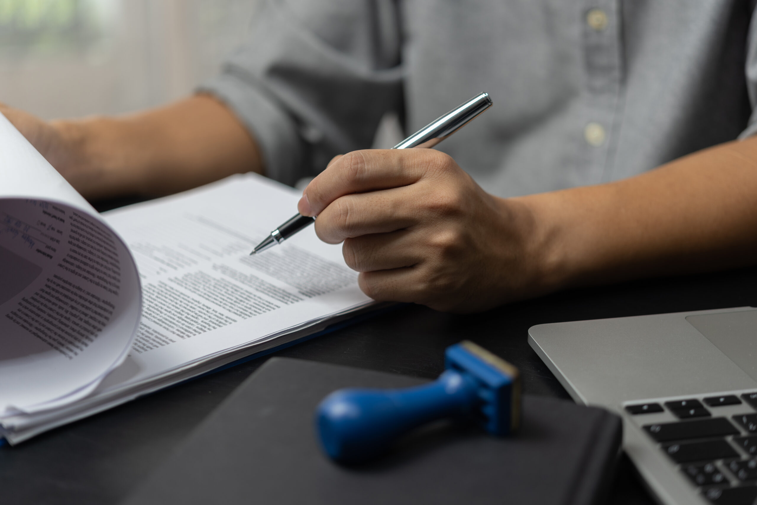 businessman agree to make deal signing document, sale contract or legal transaction contract at desk