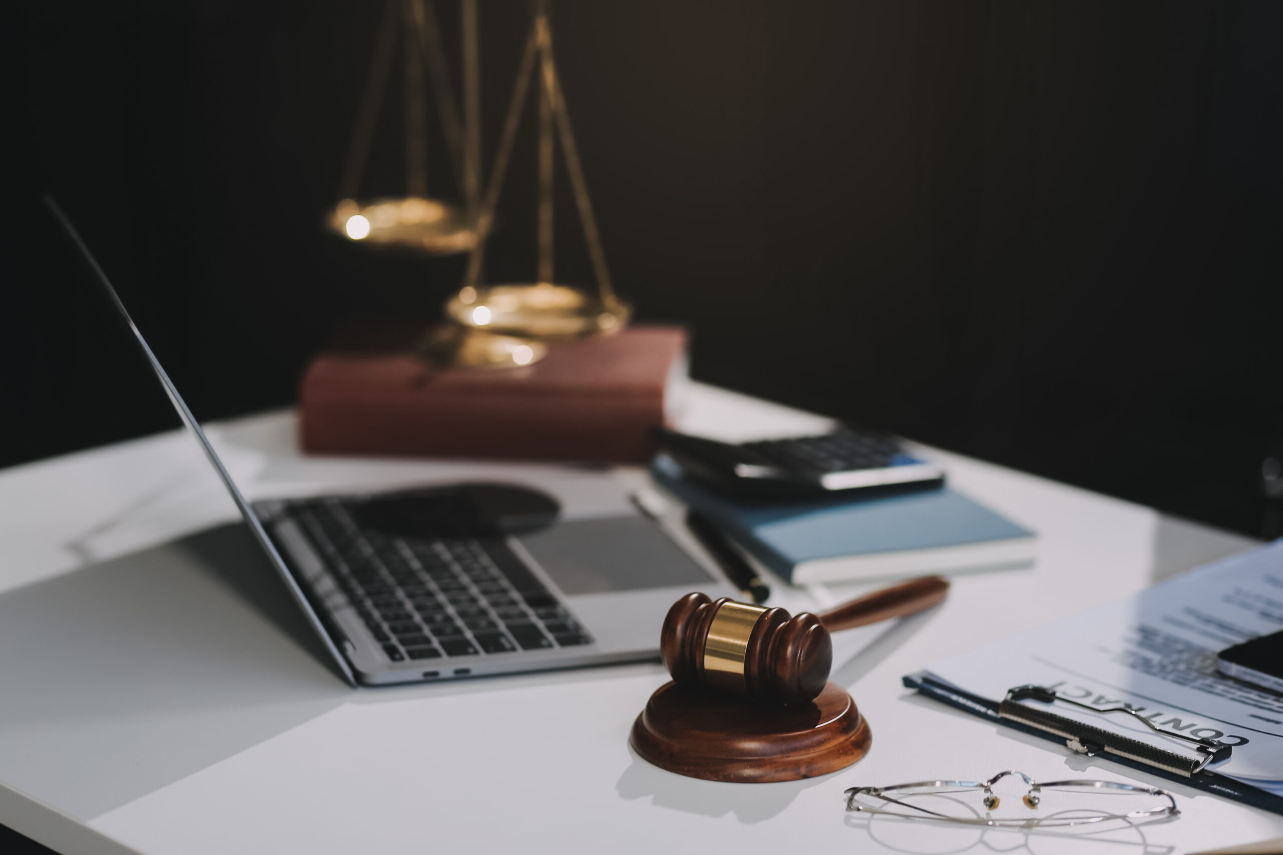 Male lawyer working with contract papers and wooden gavel on tab